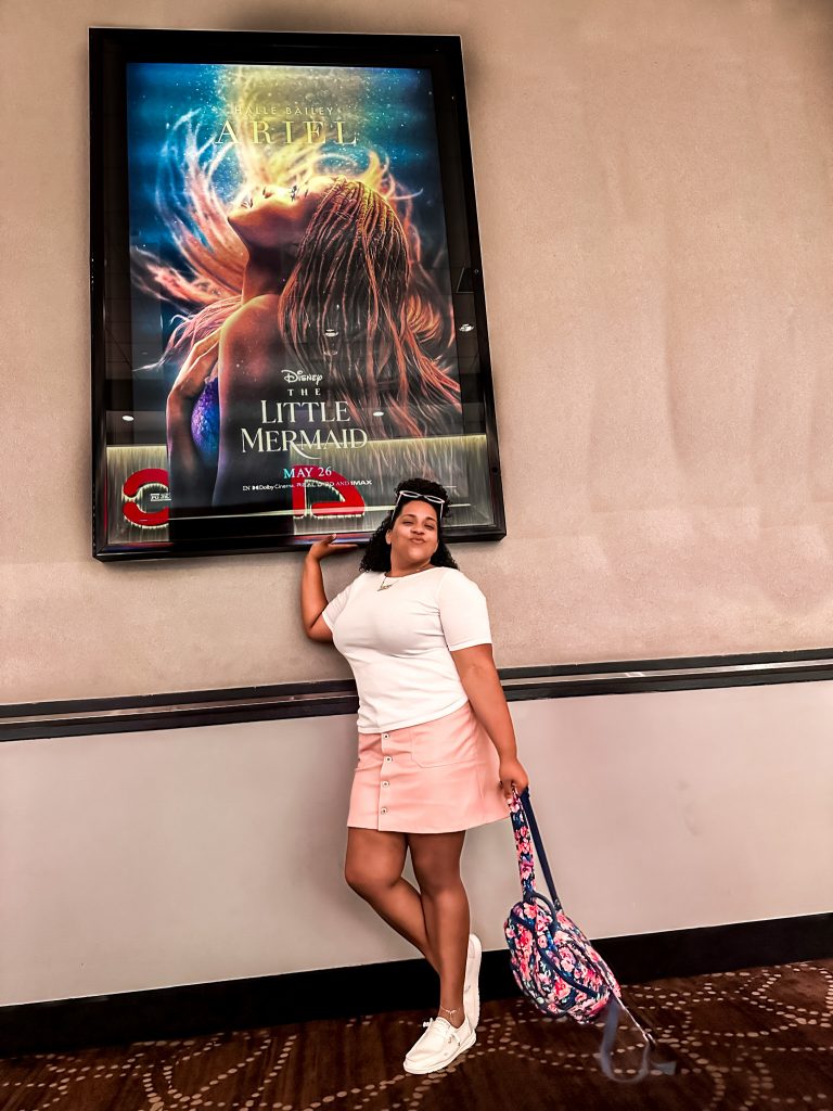 Women standing in front of The Little Mermaid Poster